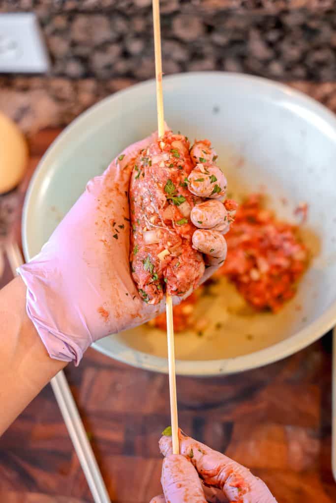 forming a kofta kabob on a wooden skewer